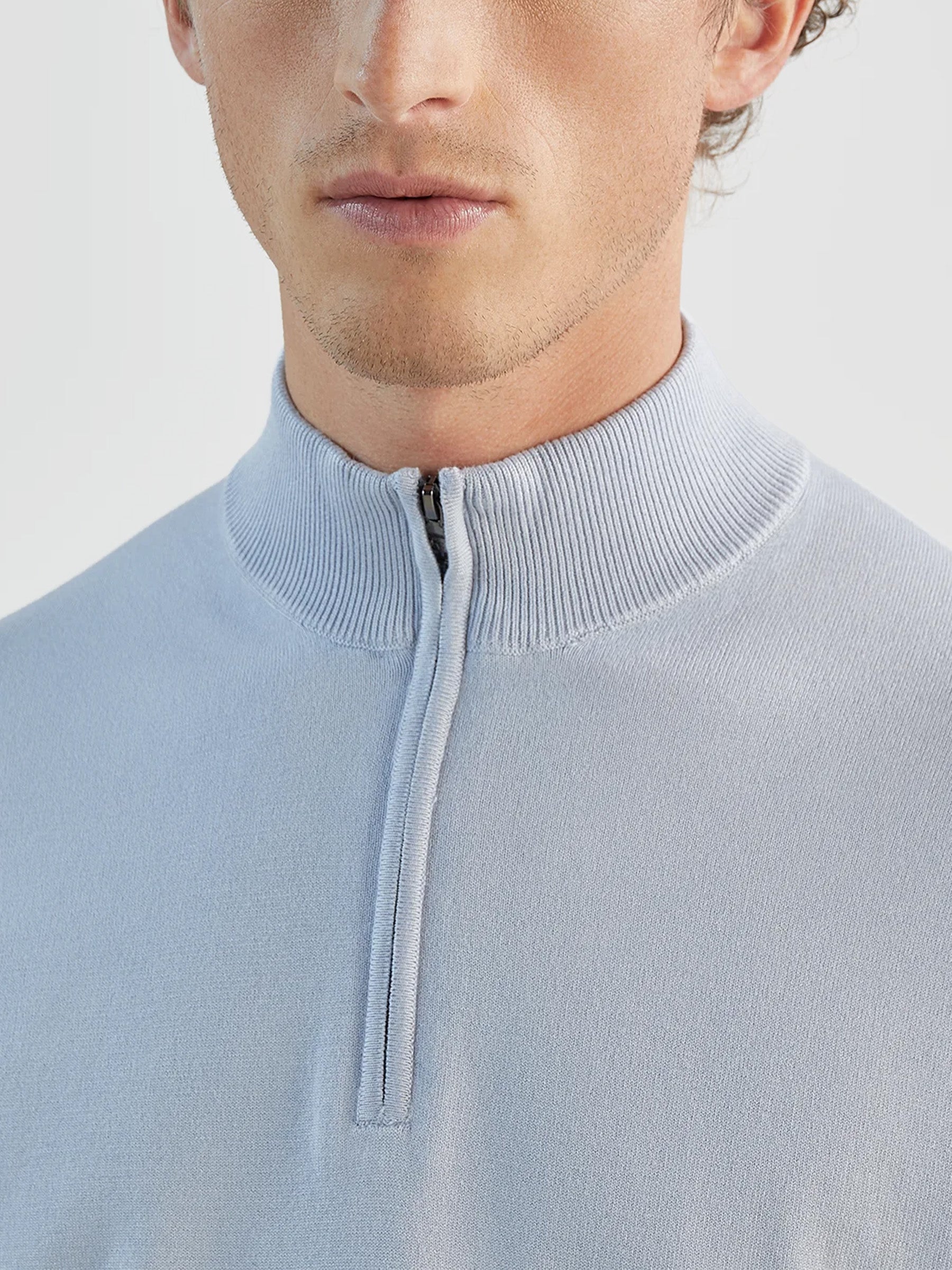 Light blue zip-neck jumper