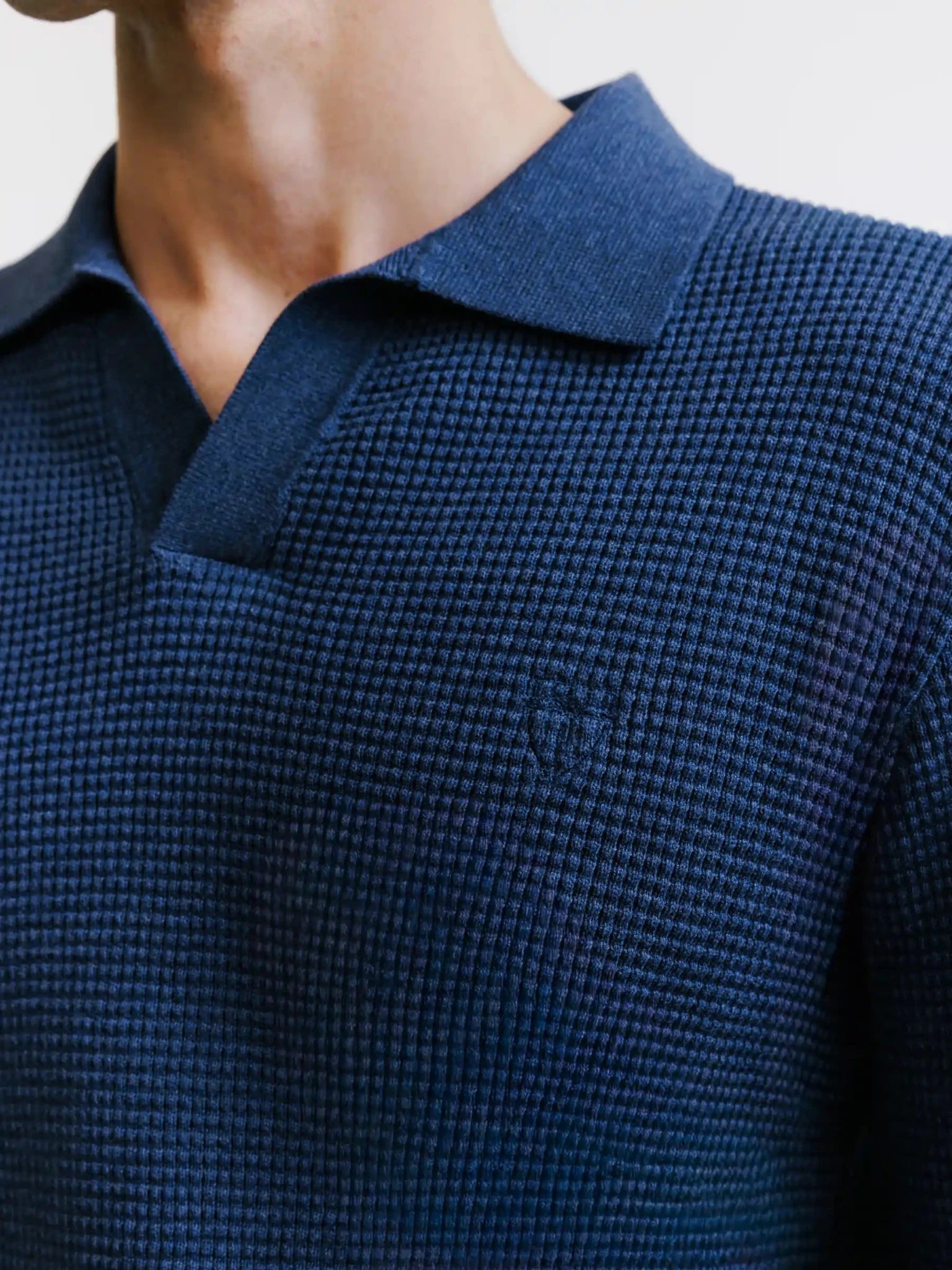 Open polo-neck jumper with indigo stitch patterns
