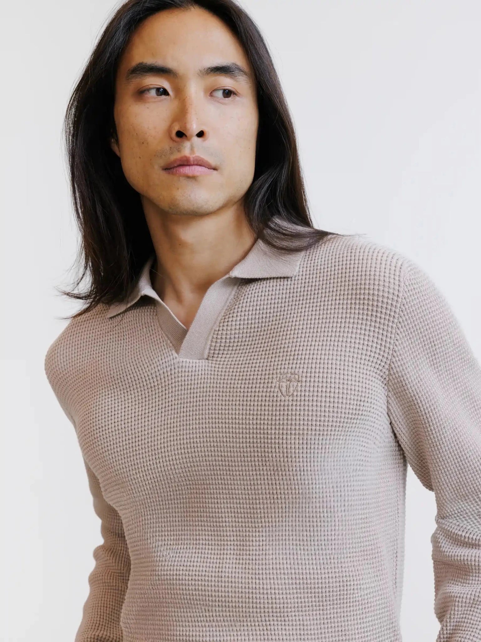 Beige open polo collar jumper with textured stitching